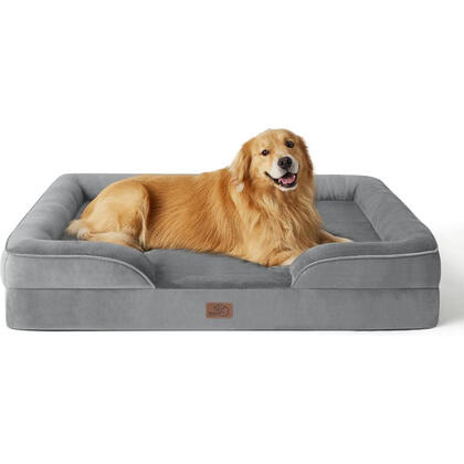 Golden retriever lounging on extra-large orthopedic dog bed with bolstered sides.